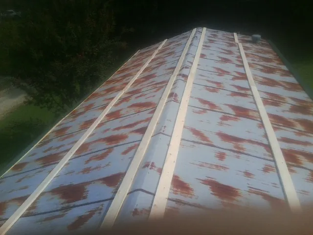 Rusted metal roof panels with new wood purlins before replacement — Storm Damage Roof Repair in Redwood by Roofing Brothers